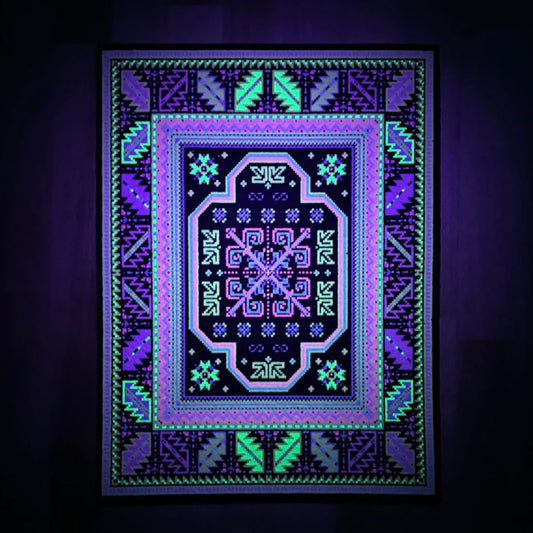 A rectangular rug with a geometric pattern featuring a central blue and purple abstract design, surrounded by a black border with additional geometric patterns in green and yellow.