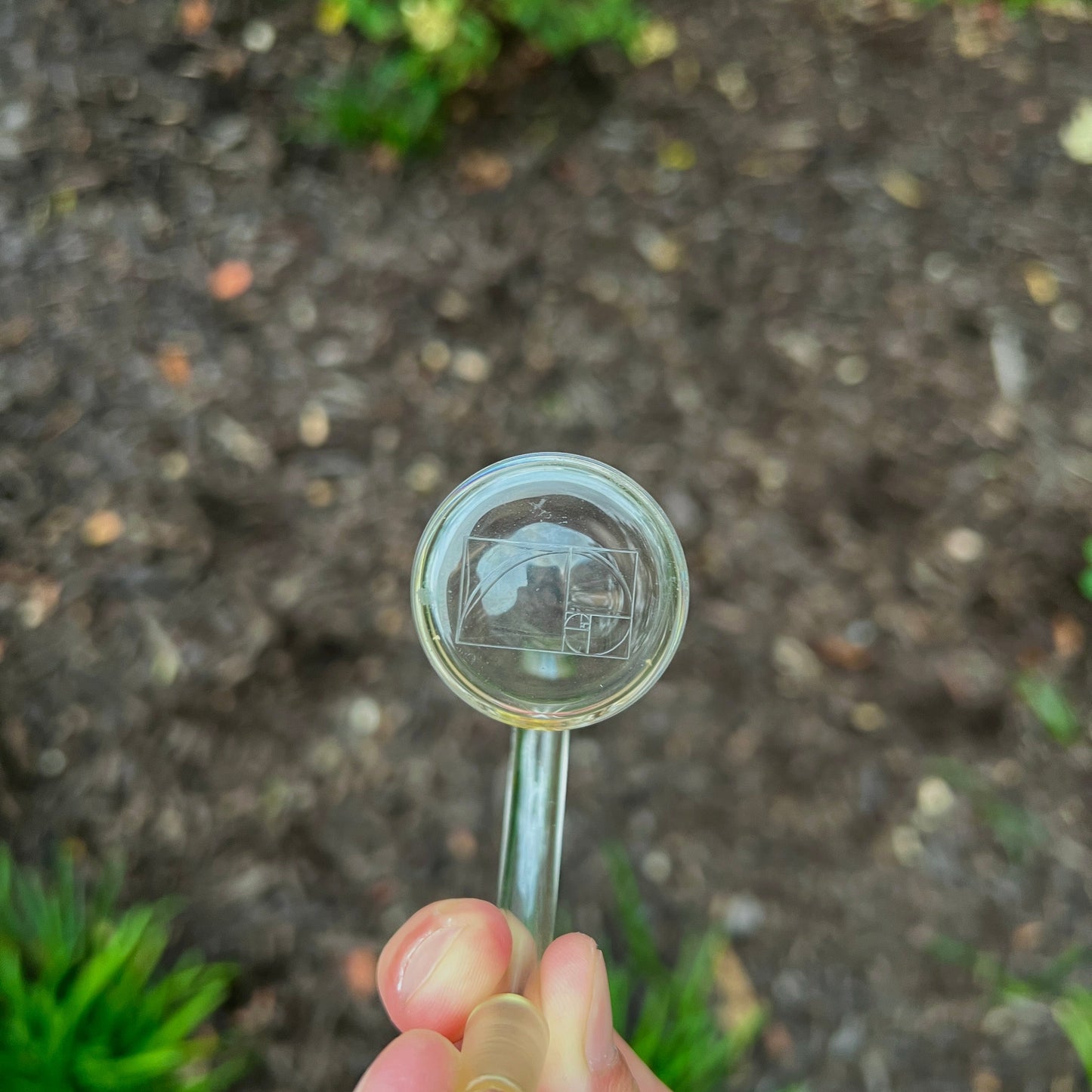 Quartz bucket with a design held by a hand against a natural background.