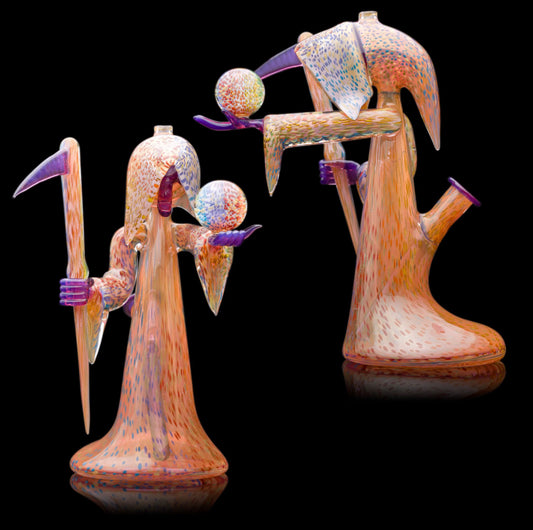Decorative glass sculpture of a reaper holding a scythe and crystal ball.