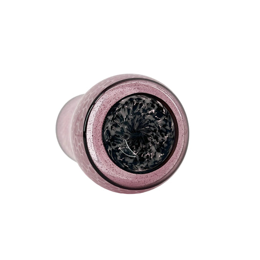 Pink glass object with black base on a white background.