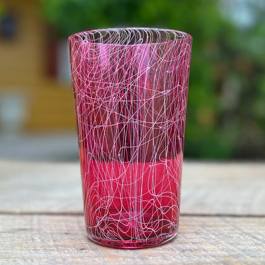 A red glass with a geometric pattern.