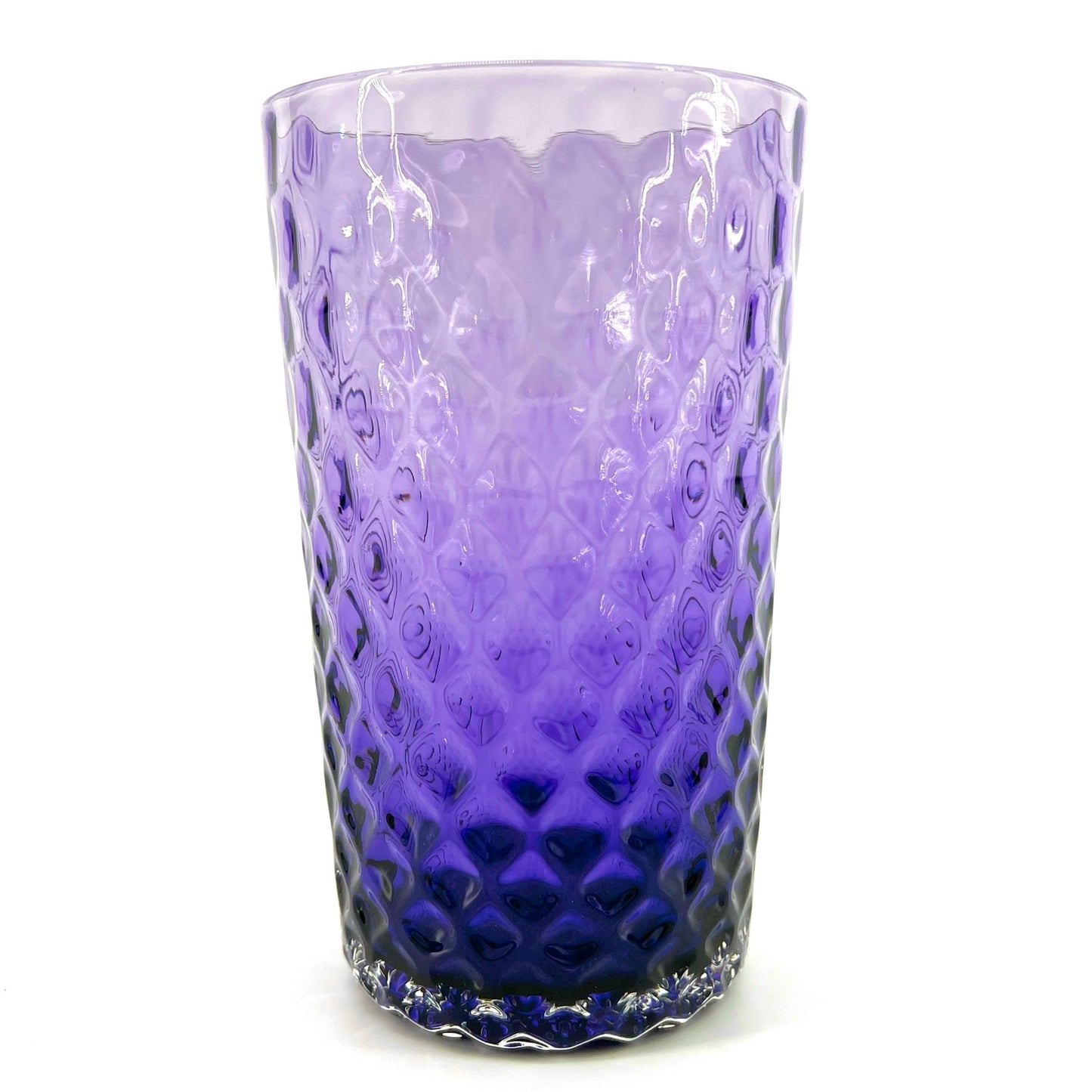 A purple glass with a geometric pattern, crafted to resemble a pineapple optic design.