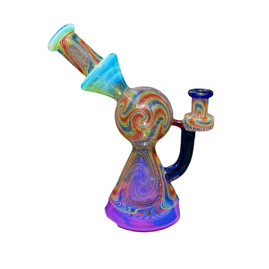 A multicolored glass piece with geometric patterns, featuring a small pyramid-shaped Perc and a narrow neck.