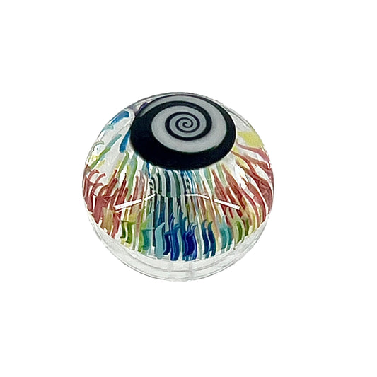 Colorful glass object with a black spiral on a white background.