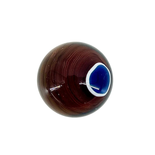 Brown glass sphere with a blue center on a white background.