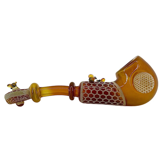Decorative glass pipe with honeycomb pattern on a white background.