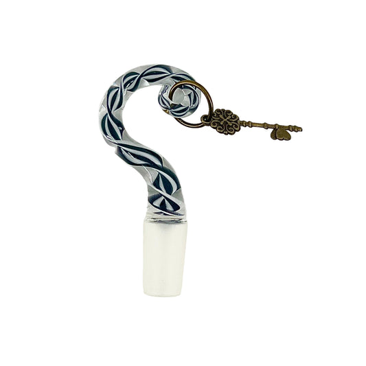 Decorative bottle stopper with twisted design and key charm on a white background