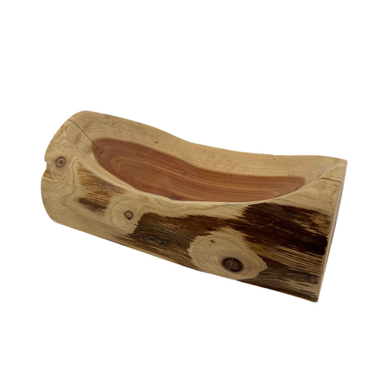 Wooden log-shaped bowl on a white background.