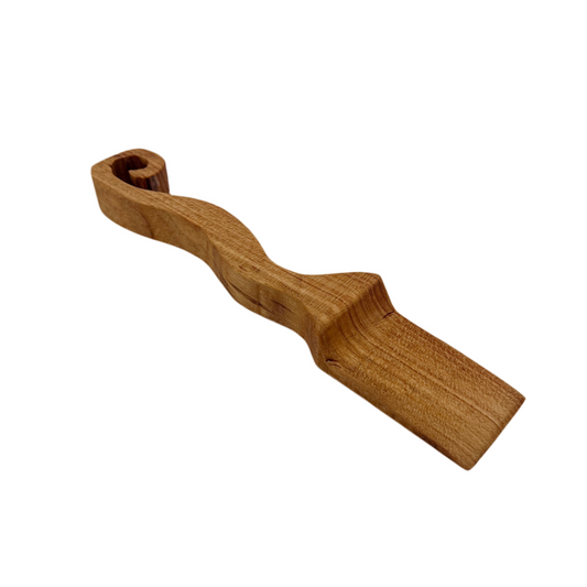 Wooden object with a curved design on a white background.