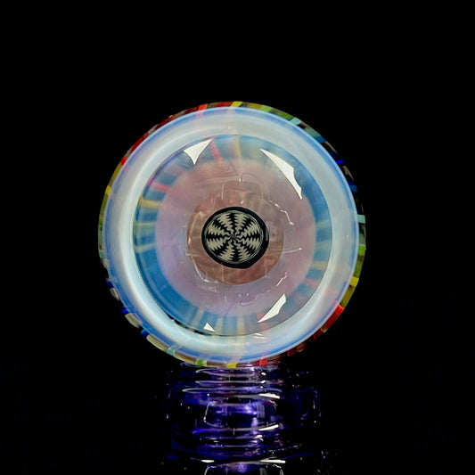 A multicolored glass marble, resembling a pinwheel, with a central hub and outer rim.
