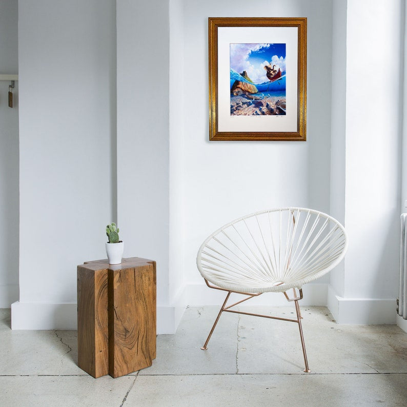 A framed artwork featuring a painting with a fantasy theme, including an elephant, a boat, and a sea turtle in an underwater setting with a blue sky above.