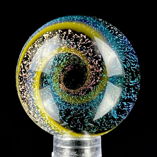 A multicolored glass marble with a visible swirling pattern, predominantly in blue and yellow hues, against a black background.
