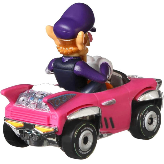 A die-cast toy car replica of Waluigi's vehicle from Mario Kart, in pink color with character details and branding.
