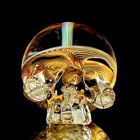 Fumed skull-shaped object on a black background