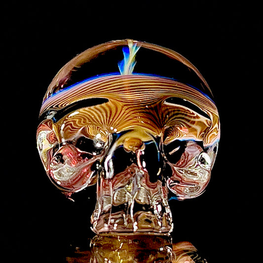 Glass skull with colorful swirls on a black background