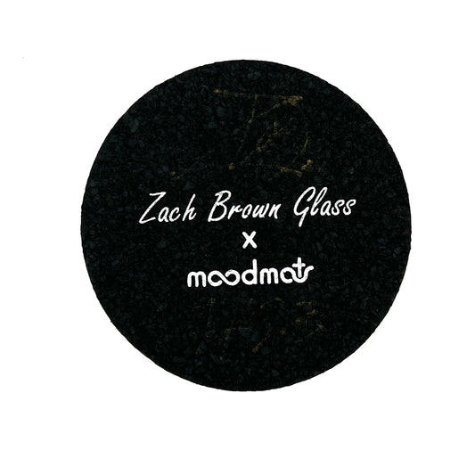 Black circular mat with 'Zach Brown Glass x moodmat' text on a white background.