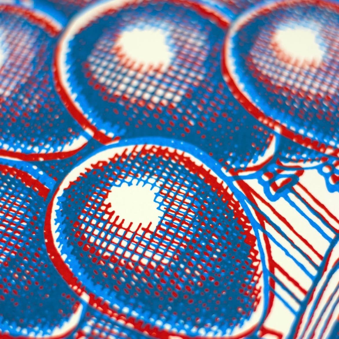Close-up of a patterned fabric with blue and red circles.