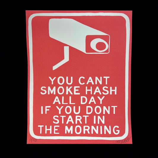 A red print with white text and a graphic of a security camera that says 'YOU CAN'T SMOKE HASH ALL DAY IF YOU DON'T START IN THE MORNING'.