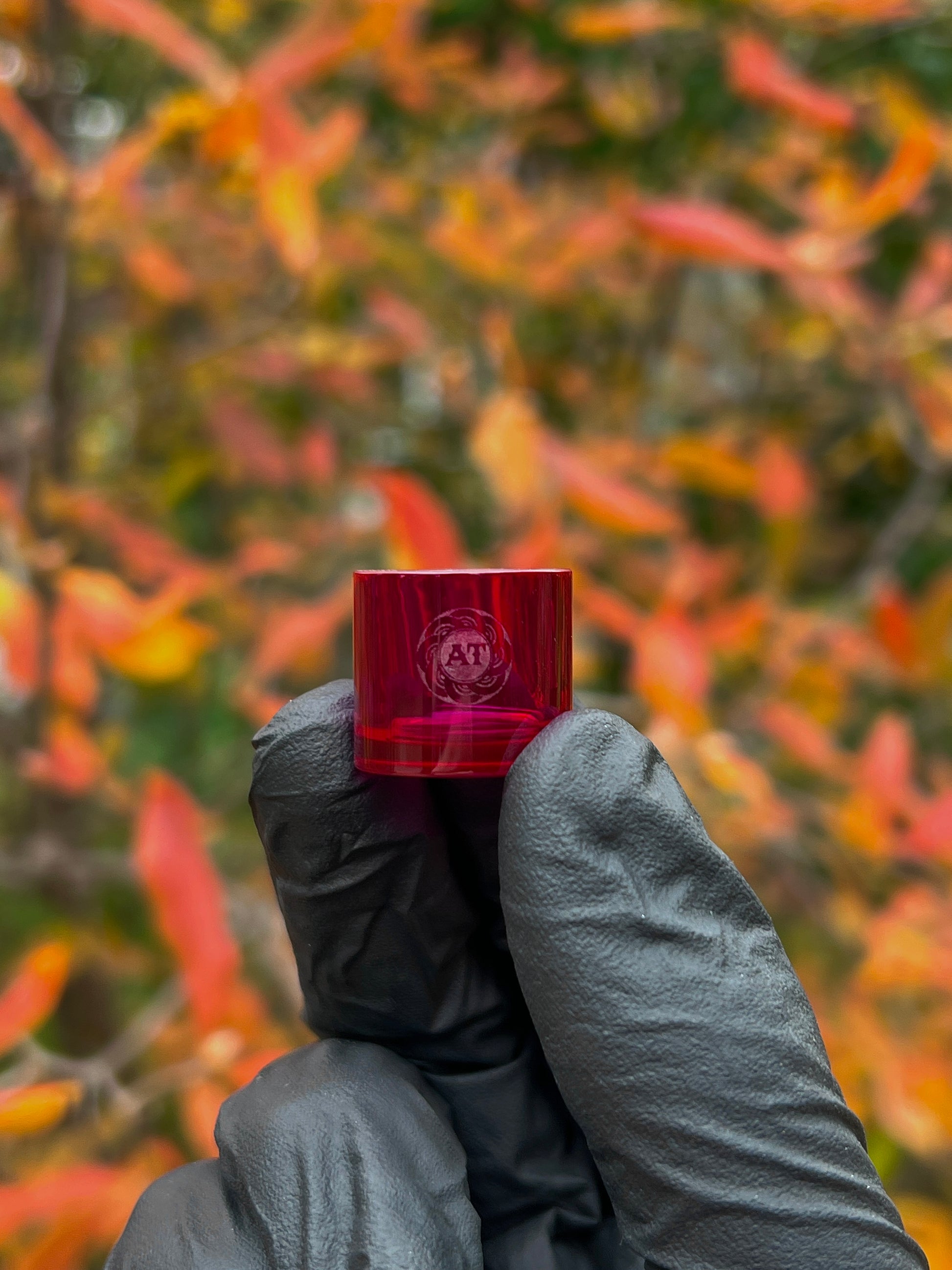 A red-colored, cylindrical Ruby insert with the Adapt Tech logo engraved on the side.