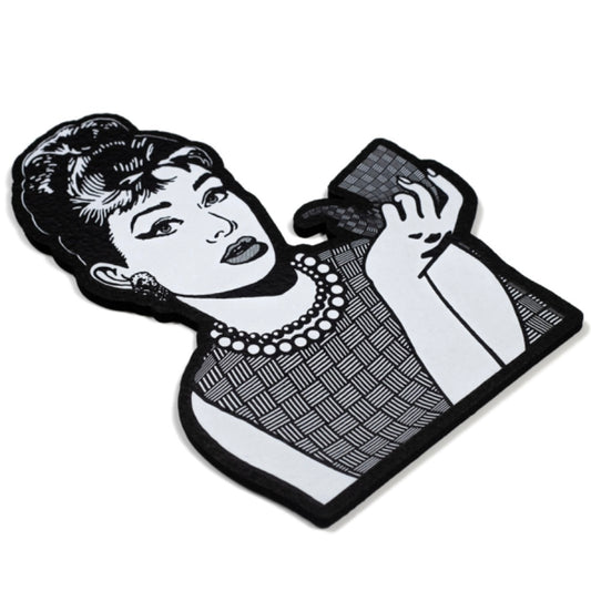 Moodmat depicting Audrey Hepburn with a sherlock, both of them covered in "chip weave," Chris Carlson's signature glass technique. 