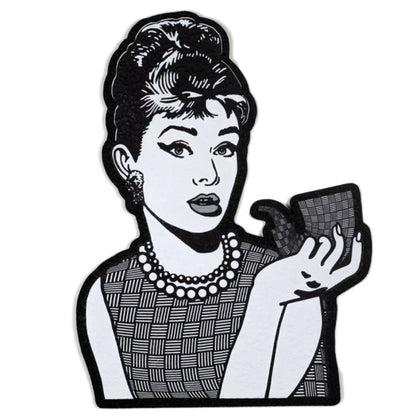 Moodmat depicting Audrey Hepburn with a sherlock, both of them covered in "chip weave," Chris Carlson's signature glass technique. 