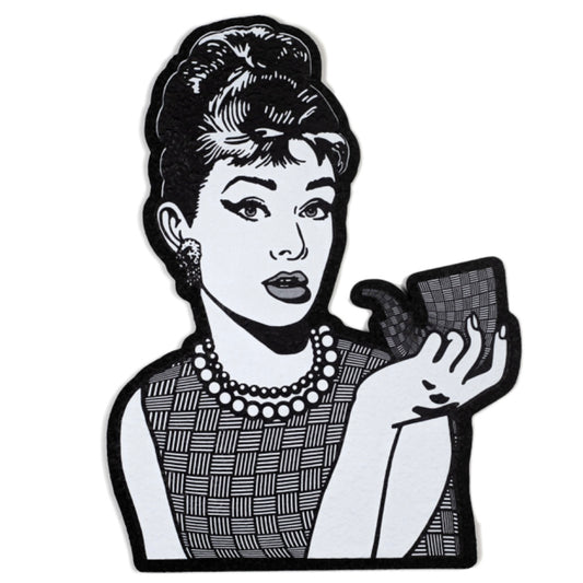 Moodmat depicting Audrey Hepburn with a sherlock, both of them covered in "chip weave," Chris Carlson's signature glass technique. 