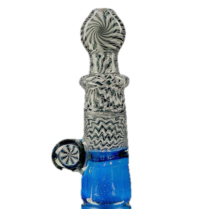 A glass one-hitter pipe with black and white geometric patterns on the body and a blue colored bowl.
