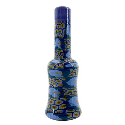 Glass mini tube with blue and yellow pattern on a white background.