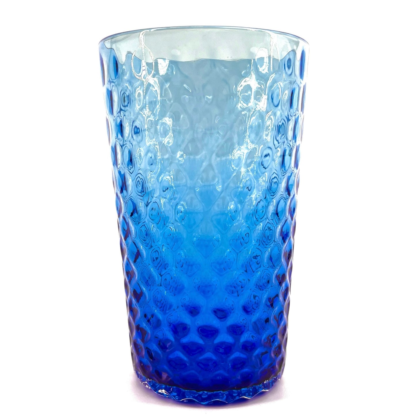 A blue glass with a geometric optic pattern.