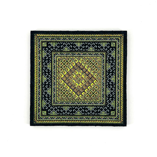 Black mat with yellow geometric pattern on a white background