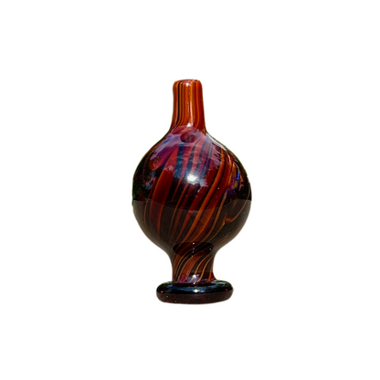 Decorative glass cap with brown and black swirl pattern on a white background