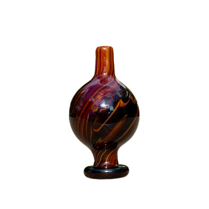 Decorative glass cap with marbled pattern on a white background.