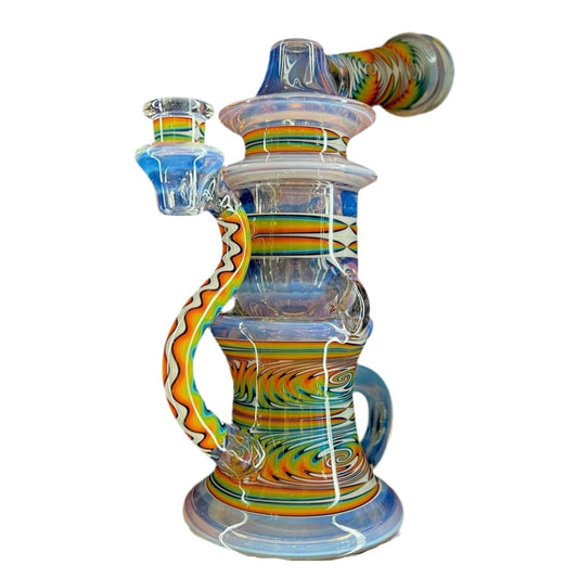 A colorful glass piece with a geometric pattern, featuring a water pipe with a 4-hole puck perc and a smaller bowl attachment.