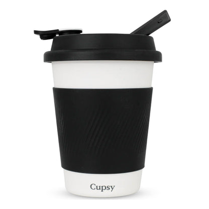 Black and white reusable coffee cup with a straw lid on a white background.