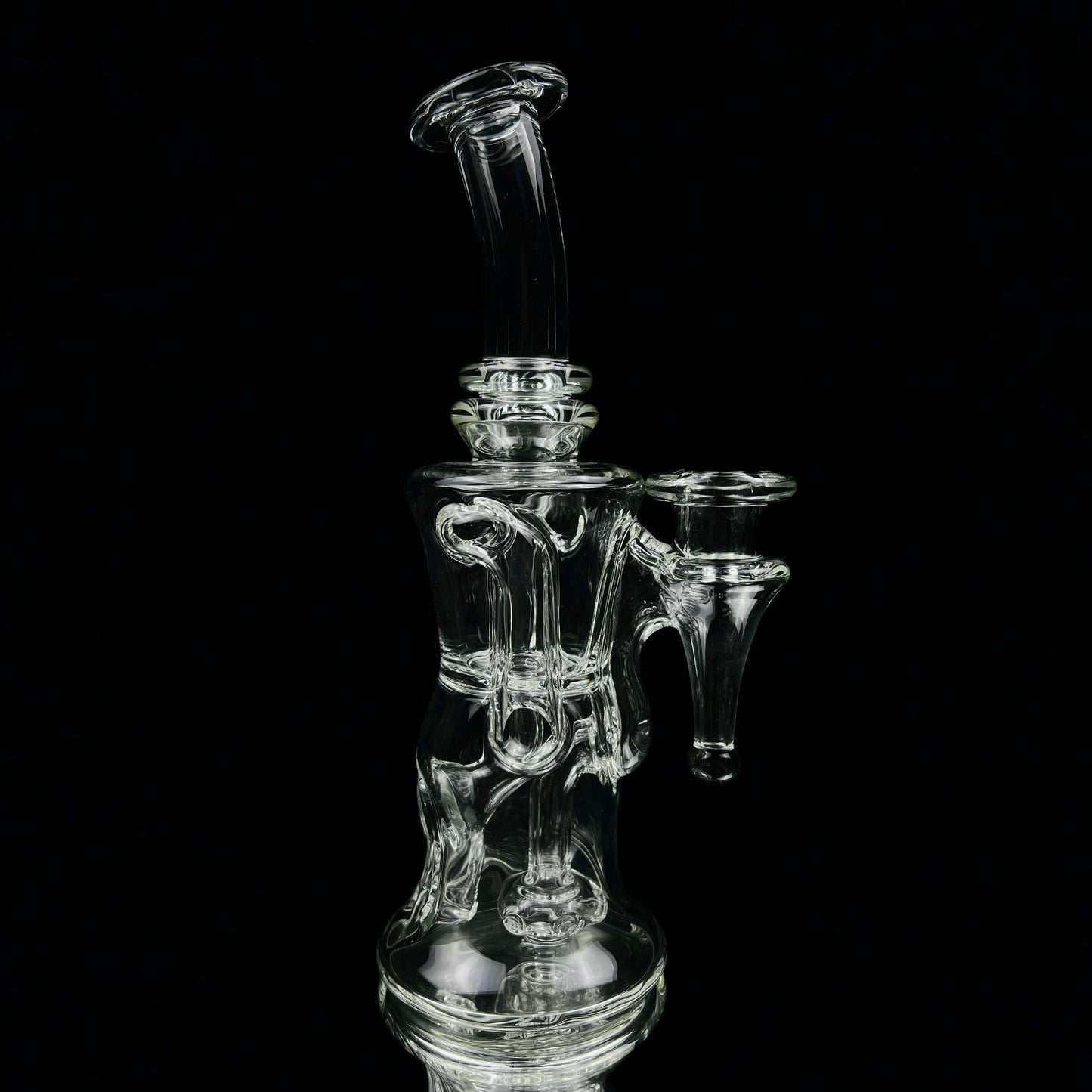 A transparent glass pipe with intricate design, featuring a 5-hole perc and a small side arm, against a black background.