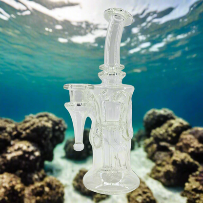 Clear glass water pipe underwater with coral