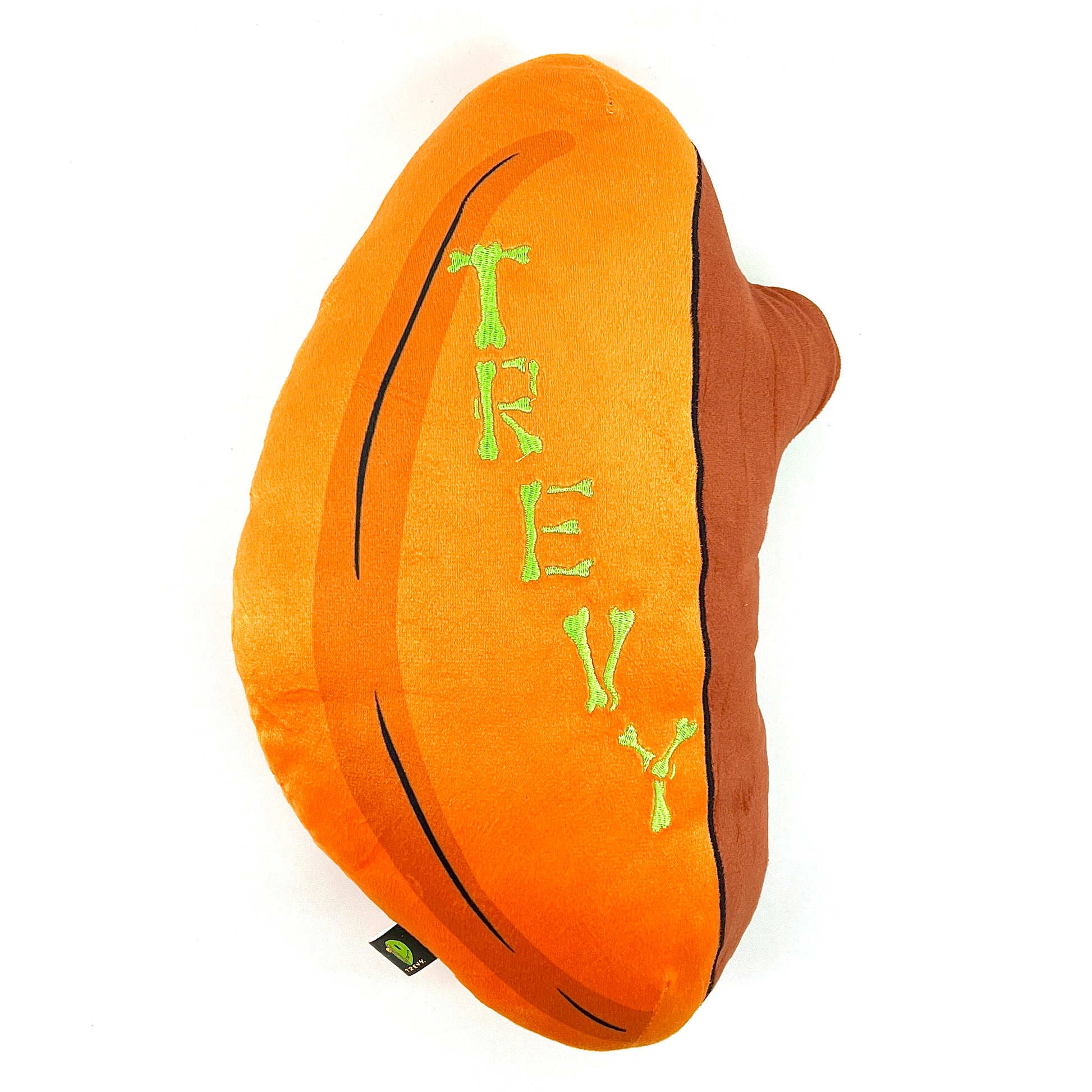 A plush toy designed by Trevy Metal featuring a skeleton peeking out from an orange shell, resembling a pumpkin.