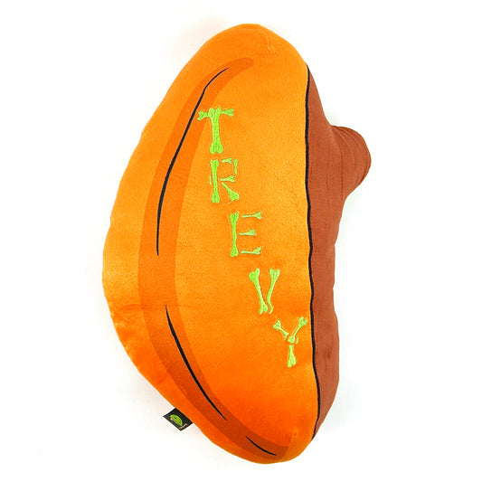 A plush toy designed by Trevy Metal featuring a skeleton peeking out from an orange shell, resembling a pumpkin.