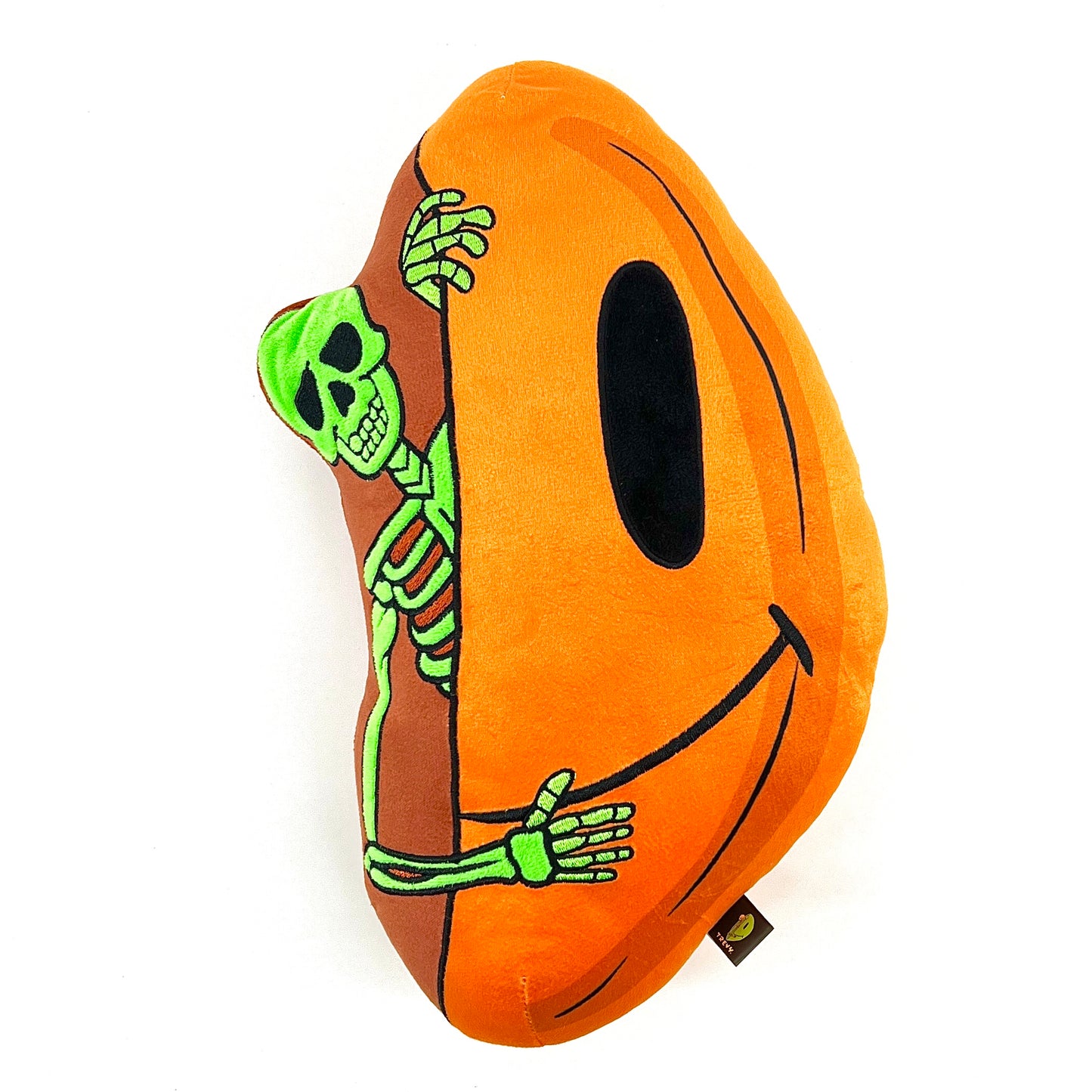 A plush toy designed by Trevy Metal featuring a skeleton peeking out from an orange shell, resembling a pumpkin.