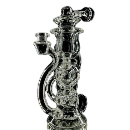 A clear glass recycler with intricate geometric patterns and a 20-hole slit and grid puck perc.