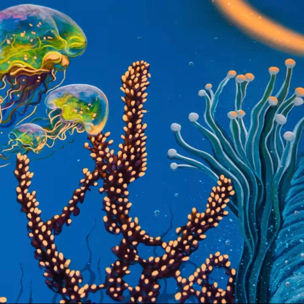 A close up of an artistic print depicting a colorful underwater scene with a central elephant figure surrounded by fish and coral.