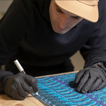 A shot of the artist signing copies of the "Nautilus" print.