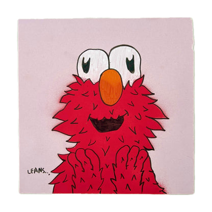 Hand-drawn red character 'Elmoh' on a pink background.