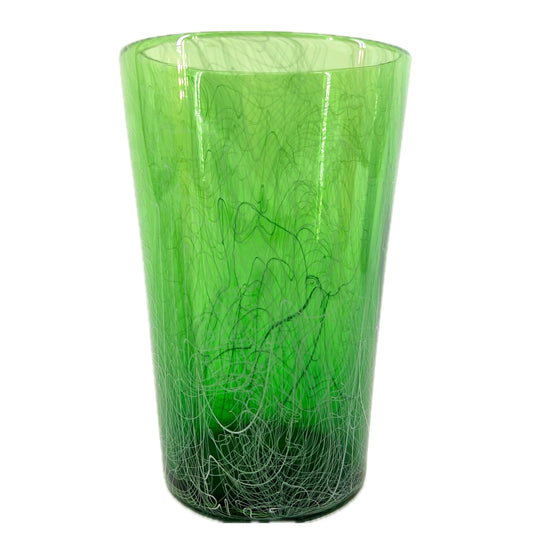 A green glass pint with unique patterns and a semi-transparent appearance.