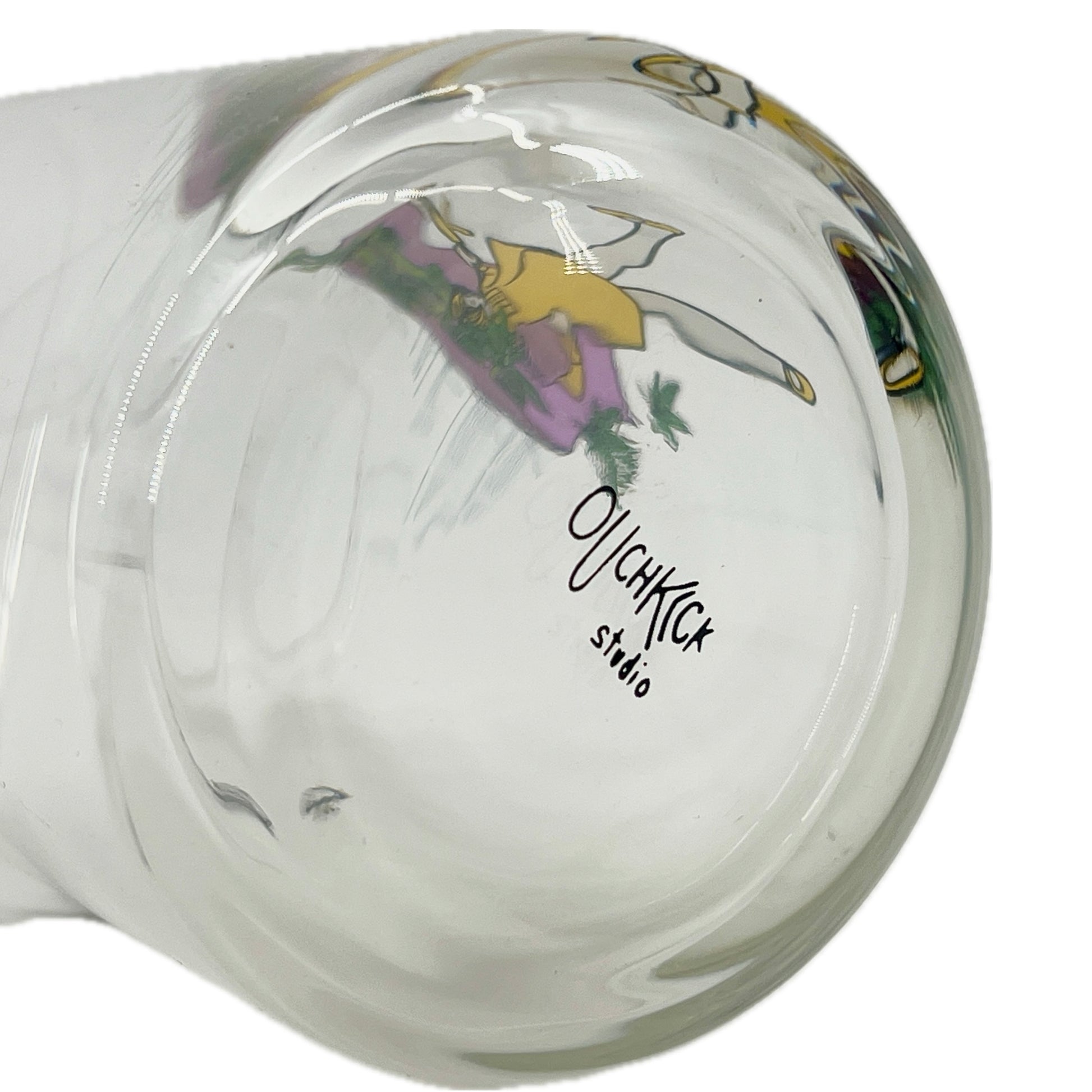 Glass mug with a colorful design and 'Ouchkick Studio' branding on a white background.