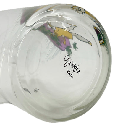 Glass mug with a colorful design and 'Ouchkick Studio' branding on a white background.