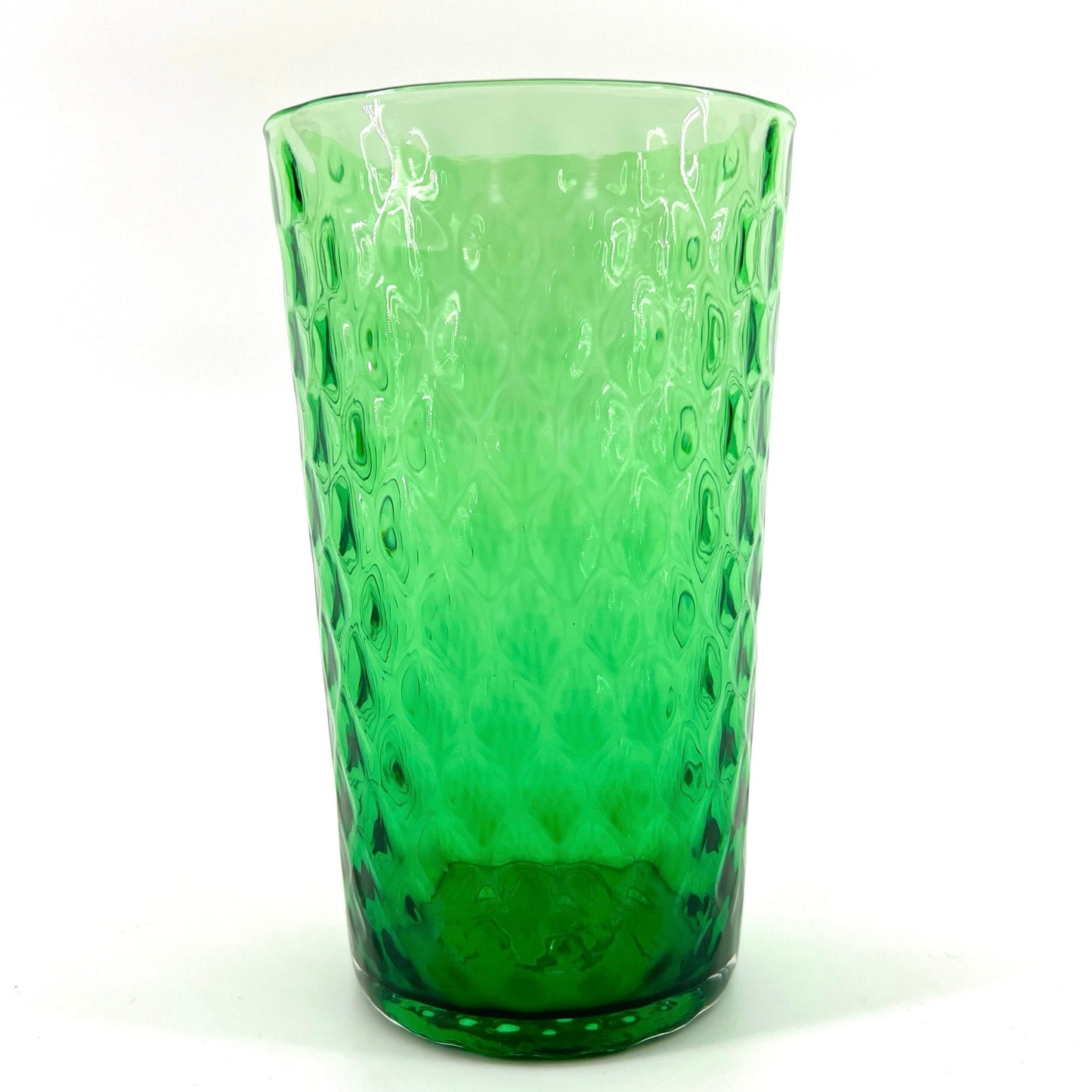 A green glass with a geometric pattern.