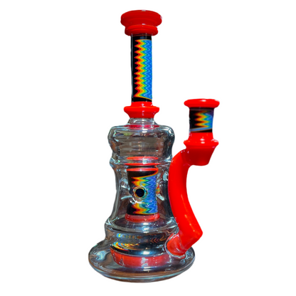 A multicolored glass piece with red accents and rainbow line work, featuring a 9-slit perc and a 14mm joint.
