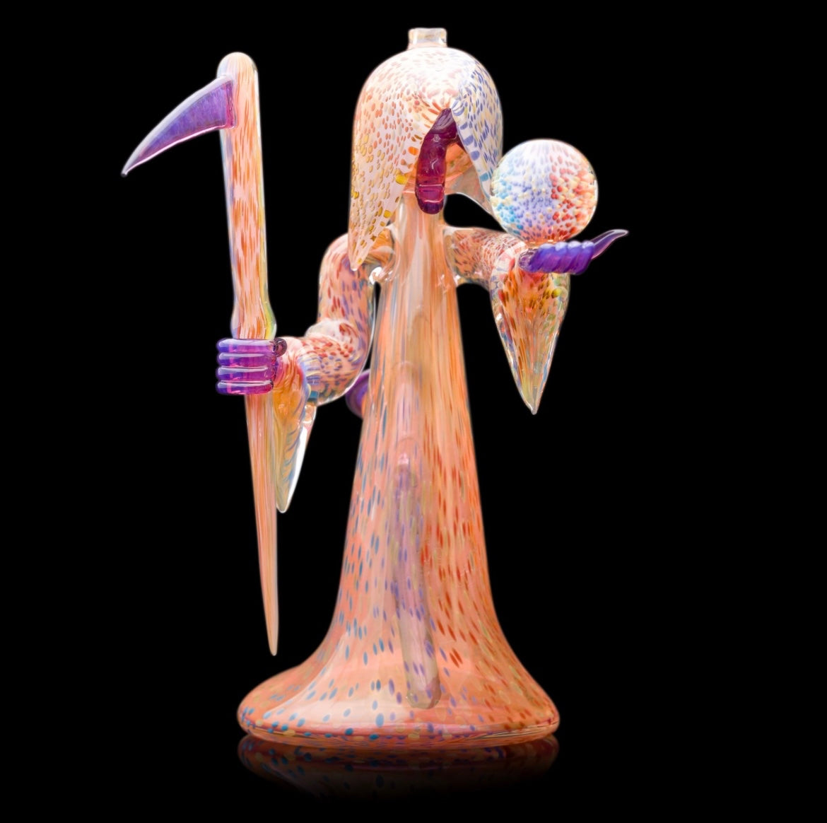 Decorative glass sculpture of a reaper holding a scythe and crystal ball.
