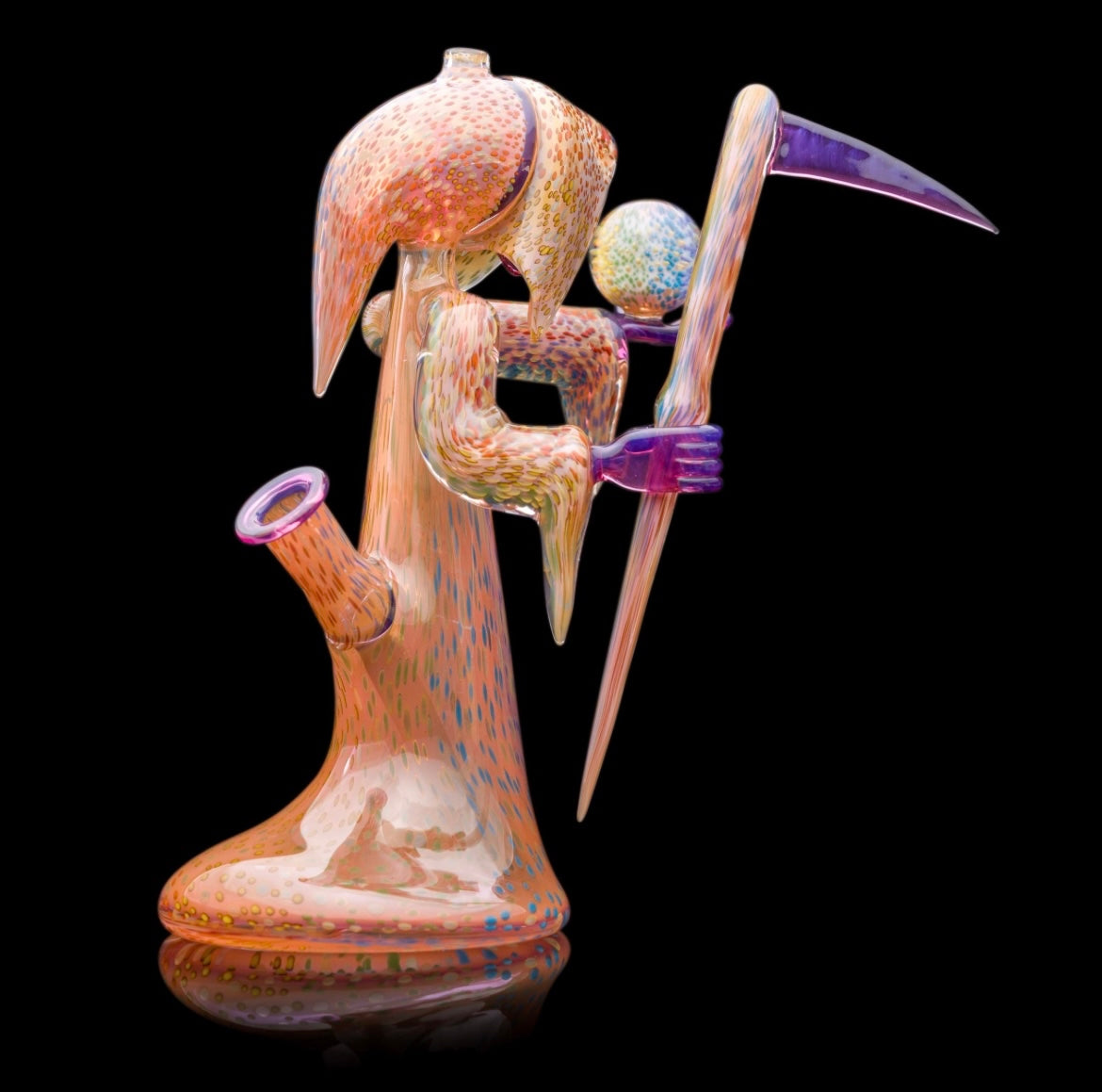 Decorative glass sculpture of a reaper holding a scythe and crystal ball.